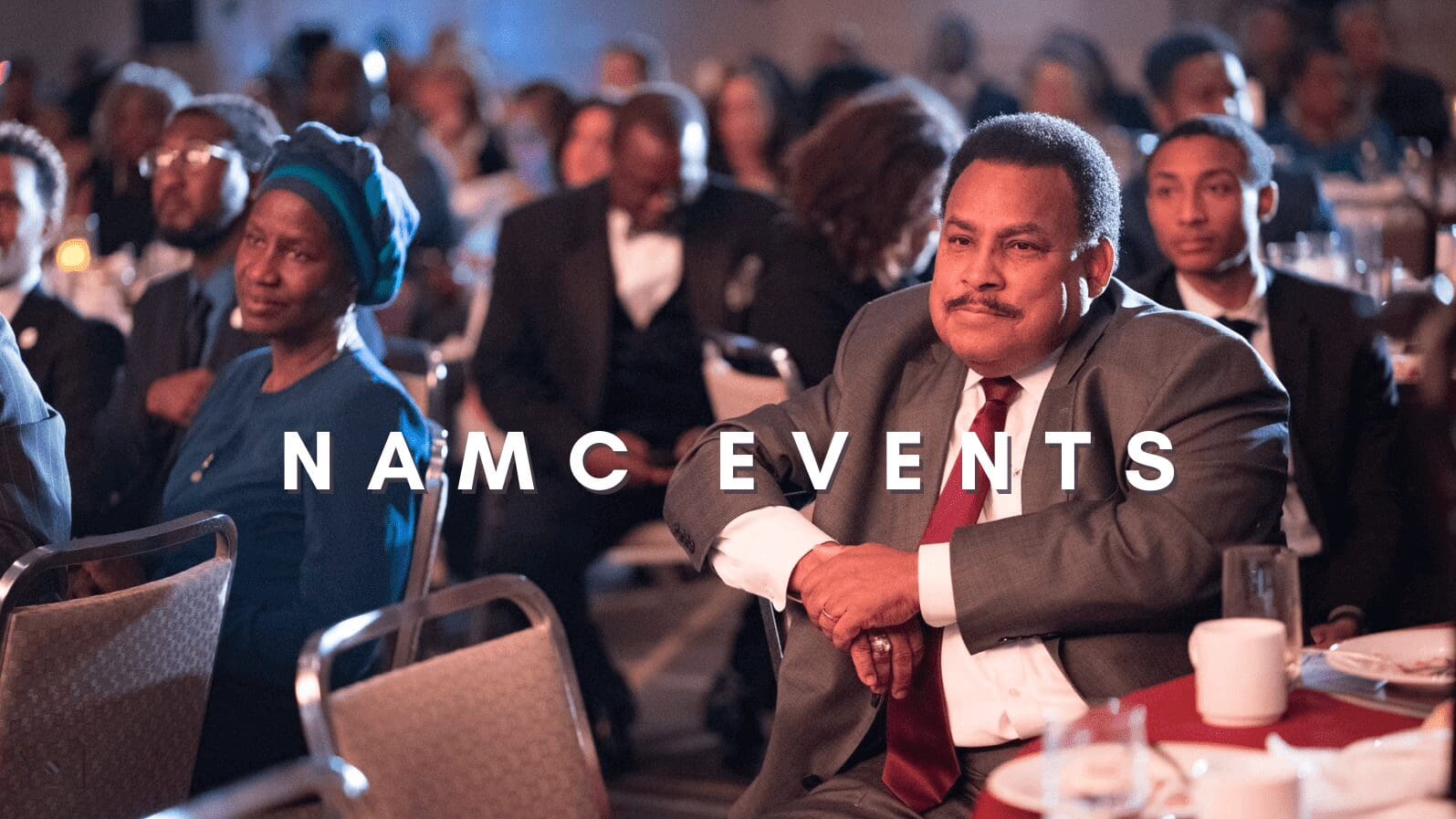 People attending formal event, seated attentively.