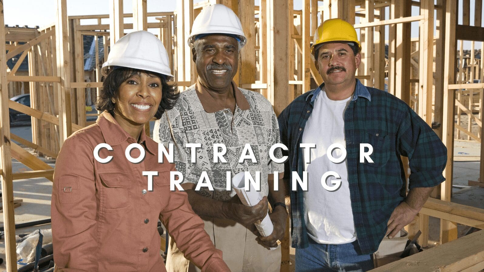Construction workers posing at building site.
